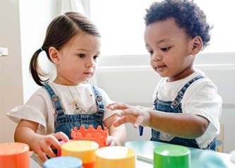 Two kids playing with blocks