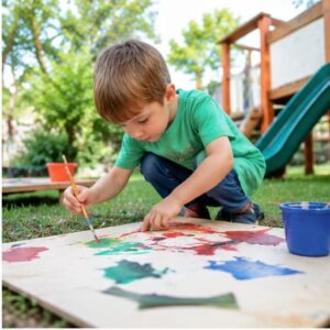 boy child making art in playground